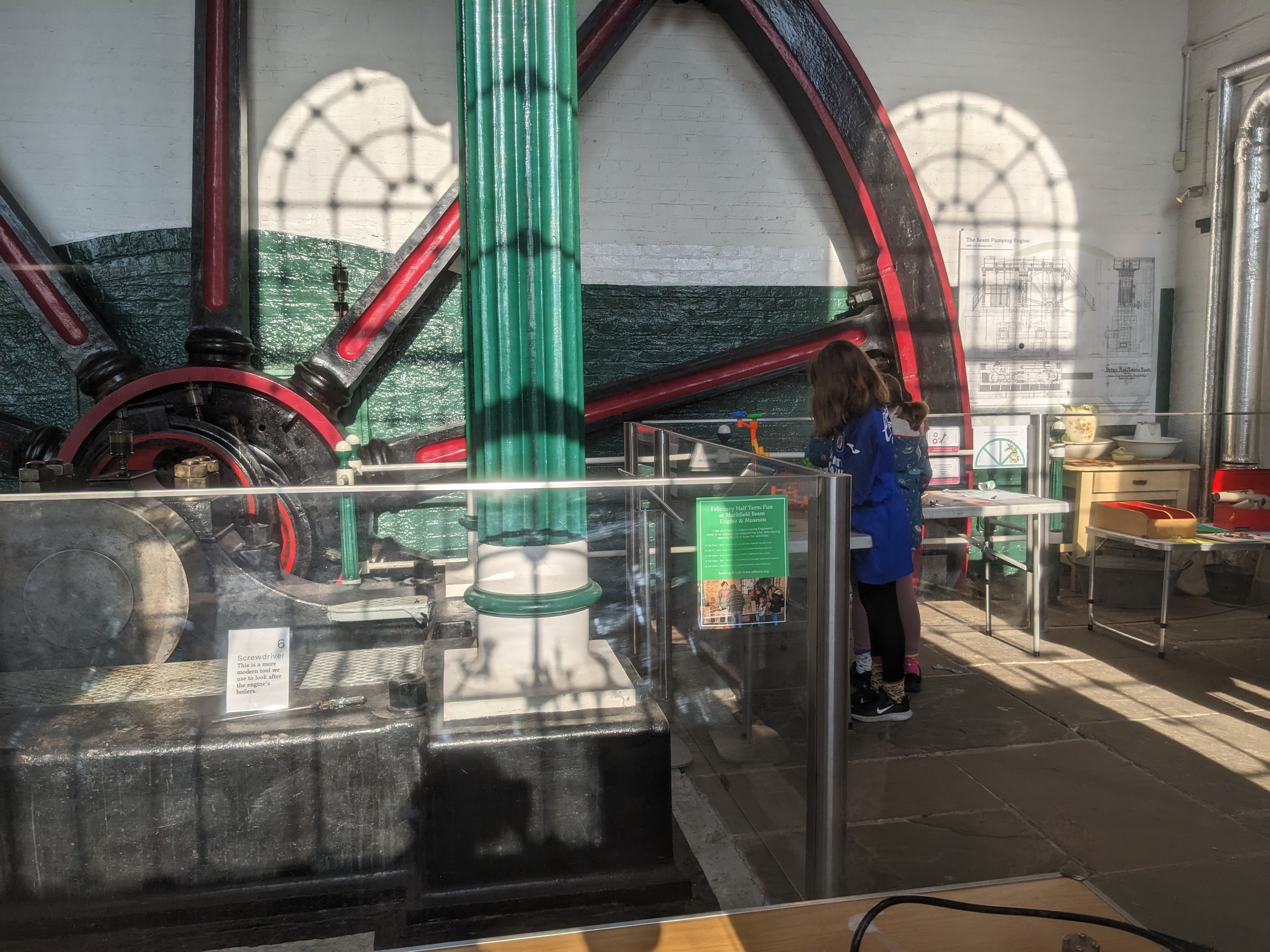 A young visitor beside the museum's beam engine, next to the family activity area